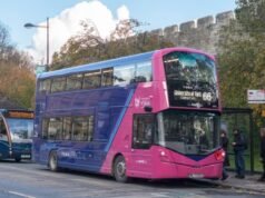 ইউকে পরীক্ষা করে যে চীনা তৈরি বাসগুলি দূরবর্তীভাবে বন্ধ করা যায় কিনা
| BanglaKagaj.in A purple and pink electric double-decker bus operated by First Bus, serving route 66 to the University of York, at a city bus stop.